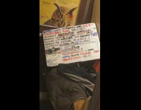 Person handwritten conspiracy sign NYPD subway train