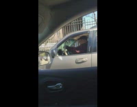 Guy in car shakes silver cylinder 