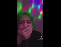 Cat drinks from womans glass of water 