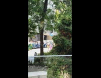 Two girls lift leg yoga pose dumpsters 