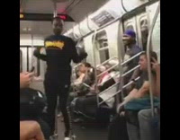 Guy in black Thrashers shirt shakes body fast and has dance battle with friend on subway train