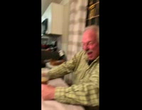 Guy dressed up as dad at dinner laughing