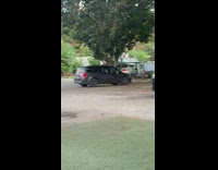 Four girls black convertible car blocks entrance