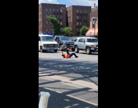 Guy lays on back holds money street 