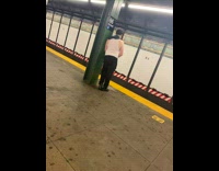 Man white tank top piss at subway