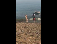 Girl red bikini grey raft beach shore
