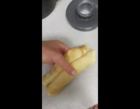 Guy feeds crepes to friend blue jacket on leather couch