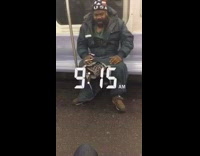 Man on subway smoking with ripped snow jacket lets out a big cough