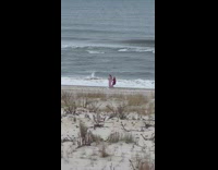 Two women tiktok dance at the beach shore