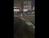 Guy lights fireworks in bottle on street and cars drive over