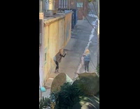 Woman give middle finger grey vest alley