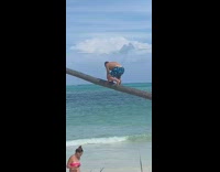 Guy in blue trunks climbs tree