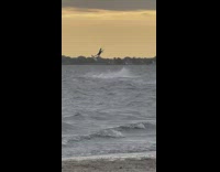 Guy kitesurfs in the air 