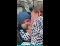 Lady Kisses Baby to Calm it Down 