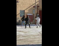 Three girls dance outside brown cabinet window 