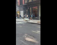 Guy extinguishes small fire on sidewalk 