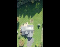 Drone shot of people mowing huge lawn