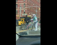 Easter bunny does wheelie on white bicycle 