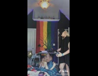 Sister puts headphones over little sister 