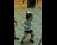 Little girl practices dancing inside dance studio 