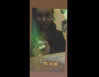 Black sweater girl holds pets cat earrings 