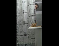 Man showering pranks cat sprinkling water