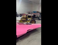 Customized pink car with bed and pillows