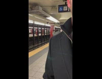 Man uses a blowdryer on his dread inside a subway station