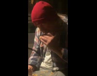 Guy eats chicken sandwich uses hand spoons