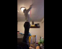 Guy hangs slinky toys on bedroom ceiling 