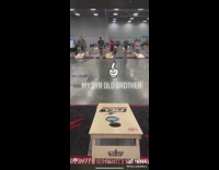 Toddler boy plays and wins cornhole game 