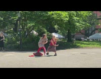 2 women swing arms and hug 