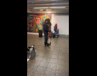 Man dances with skeleton on subway station