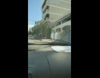 Guy walks down street wearing armor 