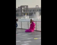 Woman pink long fluffy gown water fountain
