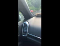 Guy rides down highway on red race cart 