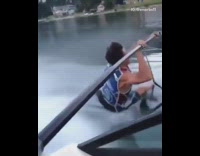 guy holds onto bar speedboat face plant