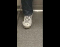 Collab Subway Creatures - Small black bug sits on mans white tennis shoe on the subway train