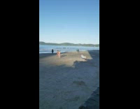 Guy brown brief dance on beach sunlight