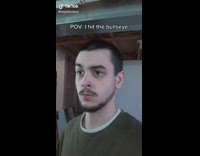 Guy green shirt playing darts hits bullseye