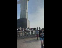 Two men tiktok dance in front of the large statue