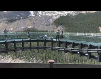 Three guys push up glass bridge mountain