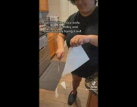 Woman uses knife and slices through paper