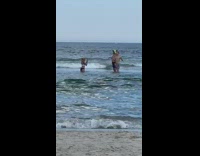 Two men shirtless back to back photo shoot beach