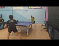 Two men compete and play table tennis