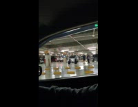 A group of people taking pictures in underground garage