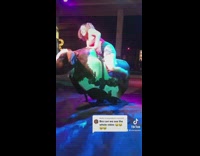 Woman rides mechanical bull front flips