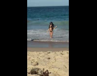 Girl black bikini face mask pose beach