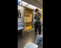 Guy does christmas songs with his hands and mouth on subway