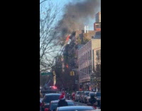 Building fire shows heavy smoke on street